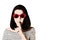 Photo in the style of pop art. Woman in red sunglasses shows gesture Shhh.