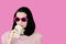 Photo in the style of pop art. Woman in sunglasses drinks coffee