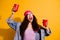 Photo of stylish lady raising red cups with beer chilling with friends wear casual trendy clothes isolated yellow color