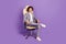 Photo of successful confident small guy sit armchair toothy smile wear grey suit isolated violet color background