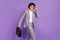 Photo of successful student pupil guy walk street carry case wear grey suit isolated violet color background