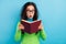 Photo of surprised amazed young woman hold read book unbelievable novel isolated on shine blue color background
