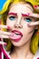 Photo of surprised young woman with professional comic pop art make-up and design manicure. Creative beauty style.