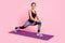 Photo of sweet adorable young woman dressed sportive outfit smiling practicing yoga stretching isolated pink color