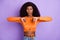 Photo of sweet annoyed dark skin lady wear orange shirt showing dislikes isolated violet color background