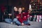 Photo of sweet cute little siblings dressed red sweaters recording video vlog modern device indoors christmas apartment