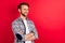 Photo of sweet handsome gentleman dressed plaid shirt spectacles arms crossed looking empty space isolated red color