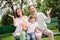 Photo of sweet impressed family dressed casual outfit waving arms sitting bench smiling outside urban city street