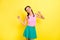 Photo of sweet pretty young woman pigtails wear tank top dancing smiling isolated yellow color background