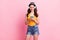 Photo of sweet shiny young lady dressed yellow tank-top typing modern device listening songs isolated pink color