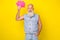 Photo of sweet thoughtful retired guy wear jeans waistcoat holding mind cloud empty space isolated yellow color