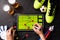 Photo of table football, soccer ball, boots, human hands with marker