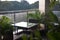 Photo of the table and two chairs on a cozy balcony with view on the rainy nature