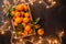 Photo of tangerines in wooden box with burning garland
