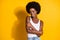 Photo of tender black young girl embrace herself wear white tank-top isolated yellow color background