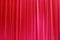 Photo Theatrical curtain of scarlet color of velvet.