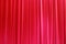 Photo Theatrical curtain of scarlet color of velvet.