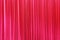 Photo Theatrical curtain of scarlet color of velvet.