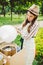 Photo theme small business cooking sweets. A young caucasian woman with an apron trader in the hat the owner of the