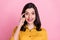 Photo of think brunette hairdo millennial lady finger head wear yellow shirt isolated on pink color background