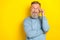 Photo of thoughtful funky man pensioner dressed blue pullover arm eyewear looking empty space isolated yellow color