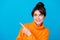 Photo of thoughtful funky woman dressed orange sweater pointing finger looking empty space isolated blue color