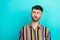 Photo of thoughtful positive serious man with brunet hair dressed striped shirt look empty space  on turquoise