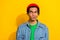 Photo of thoughtful suspicious man wear jeans shirt red hat looking empty space isolated yellow color background