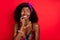 Photo of thoughtful tricky wavy dark skin lady wear pin up outfit biting finger looking empty space isolated red color
