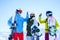 Photo of three athletes in helmet doing handshake at snow resort.