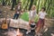 Photo of three busy friends prepare campfire meal carry supplies wear casual outfit nature woods outdoors