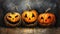 Photo of three Halloween pumpkins sitting on a table