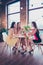 Photo of three ladies sit in modern coffee shop enjoy anniversary spring free time telling gossips