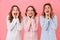 Photo of three lovely women 20s wearing colorful striped pajamas