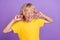Photo of tired annoyed boy avoid noise fingers cover ears wear yellow t-shirt isolated purple color background