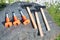 Photo of tools for working with rocks. Stone processing tools for splitting boulders. Chisels and hammers lie on a large