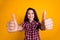 Photo of toothy beaming woman with wavy hairdo dressed checkered shirt showing thumbs up to you good job isolated on
