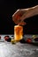 Photo on top of frozen fruit juice, human hand and berries