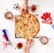 Photo top of hands of football fans with mugs of beer, pizza at white table