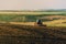 Photo of tractor cultivating a land, preparation for new year