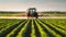 photo of a Tractor spraying pesticides in field