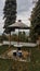 Photo of a traditional dining place on top of a mountain with a view of dense green trees