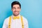 Photo of tricky funny guy wear yellow suspenders white shirt looking empty space isolated blue color background