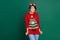 Photo of tricky funny lady wear red sweater horns hair band biting lip isolated green color background
