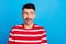 Photo of tricky funny young guy dressed red t-shirt looking empty space isolated blue color background