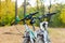 Photo of two bicycles on blurred background of autumn park
