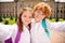 Photo of two cheerful positive schoolkids sister brother make selfie wear rucksack white shirt uniform park outside