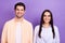 Photo of two cheerful satisfied people beaming toothy smile isolated on violet color background