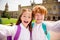 Photo of two crazy excited schoolkids make selfie have break fun wear bag white shirt uniform park outside