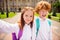 Photo of two funny schoolchildren girl smile boy grimace blogging take selfie wear bag white shirt uniform park outside